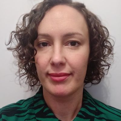 white woman, dark curly hair, white background